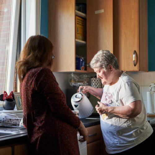 Older woman making a cup of tea