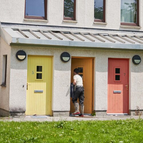 Man walking through his front door