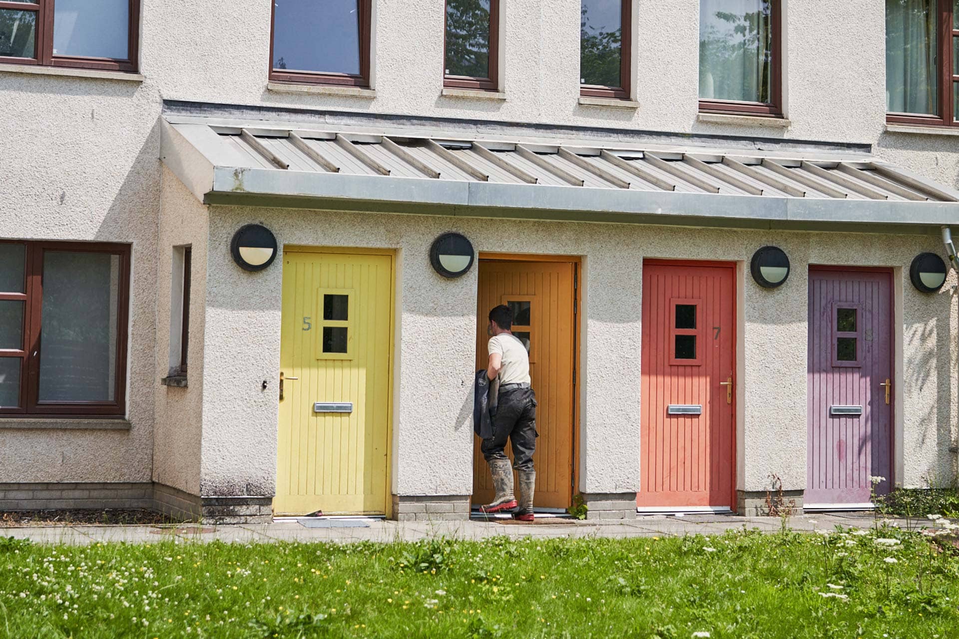 Man walking through his front door