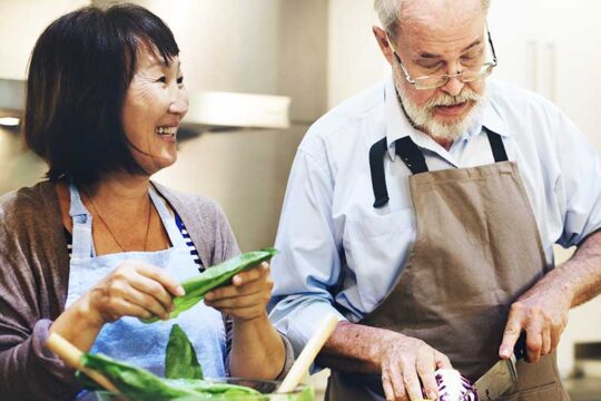 A man and a woman preparing ingredients