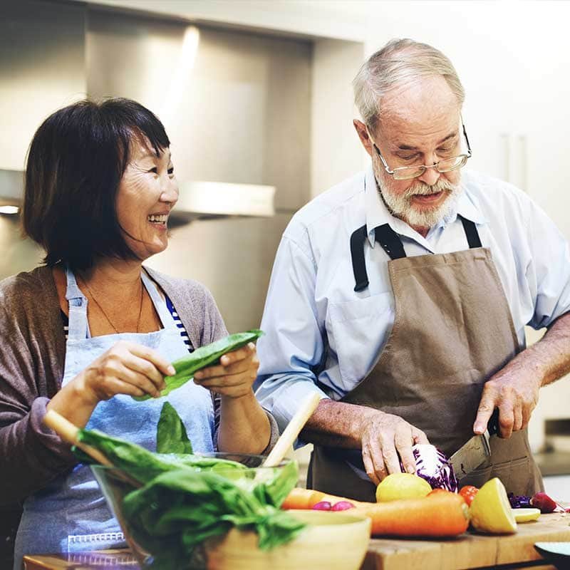A man and a woman preparing ingredients