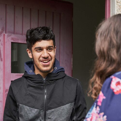 Man standing outside his front door