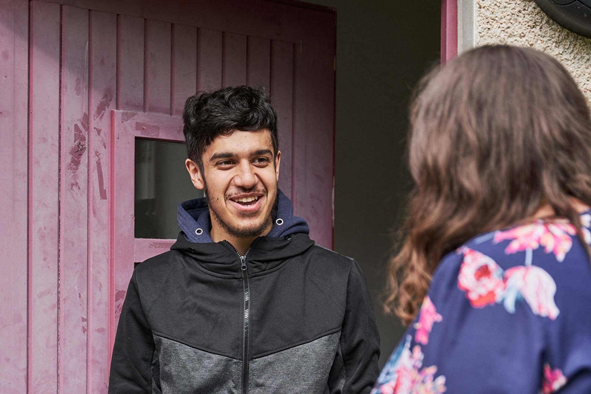 Man standing outside his front door