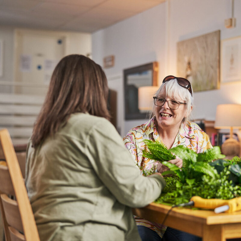 Two women sitting at table talking