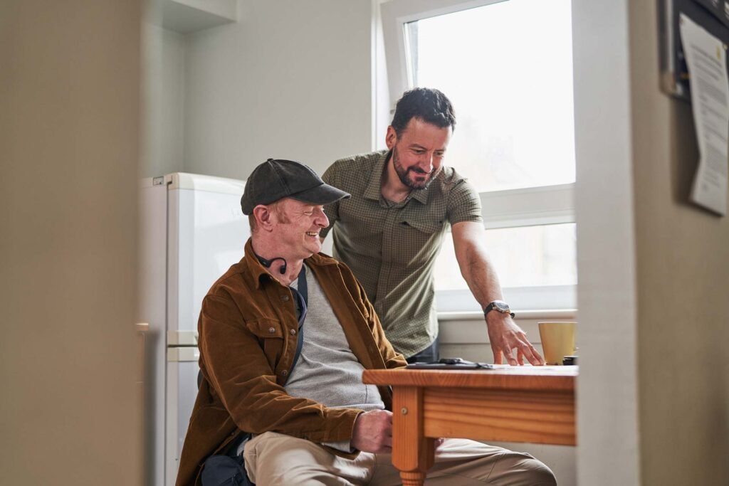 Two people working at a kitchen table