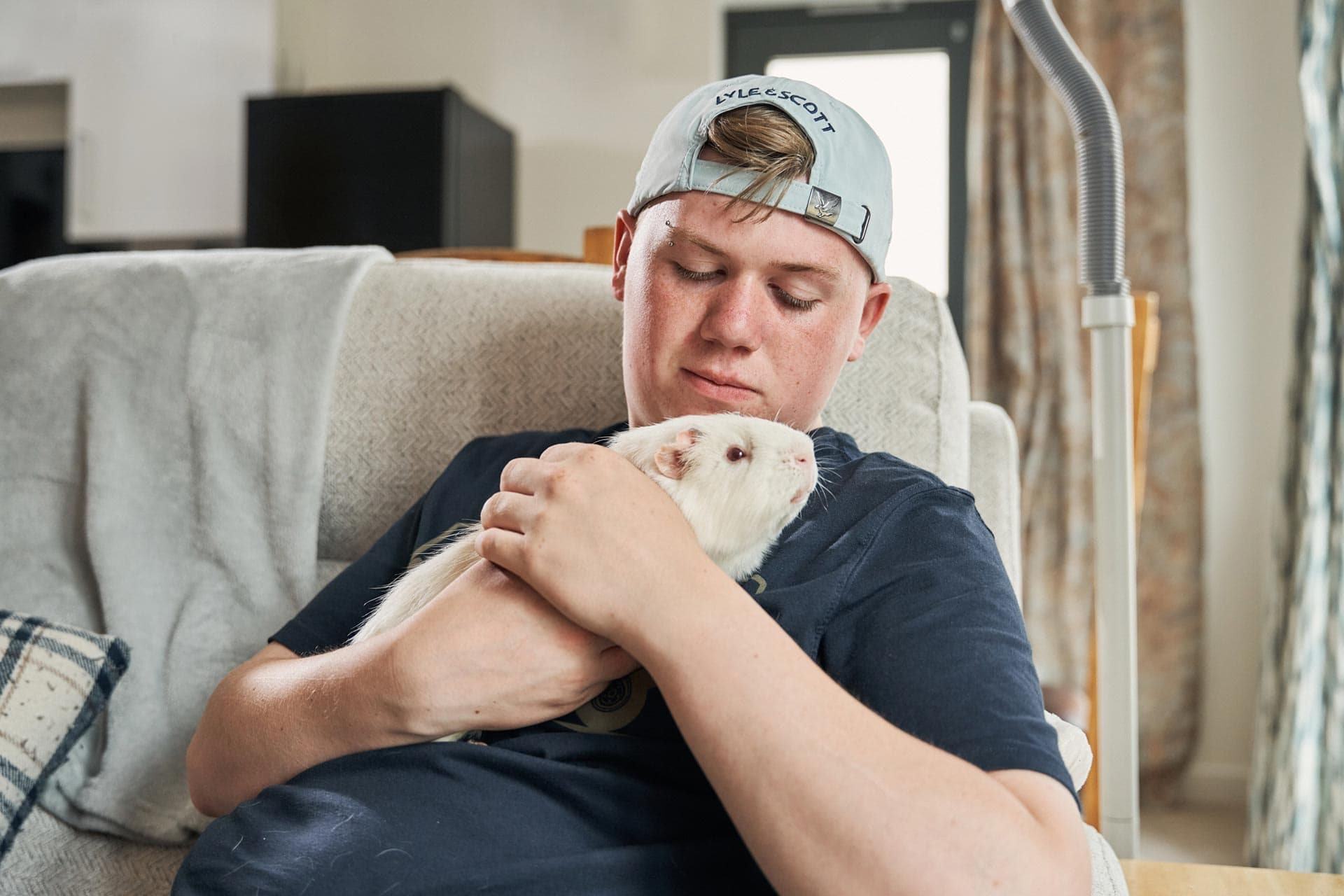 Man playing with a guinea pig