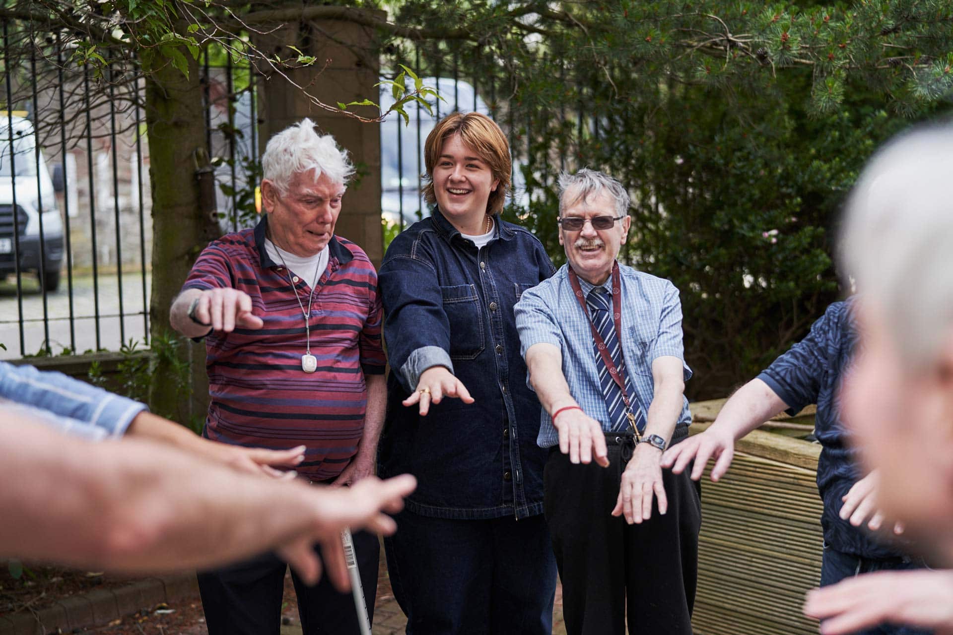 Group of people smiling in a circle