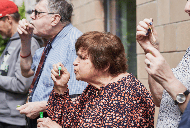 Care Support Scotland - outside residents blow bubbles together