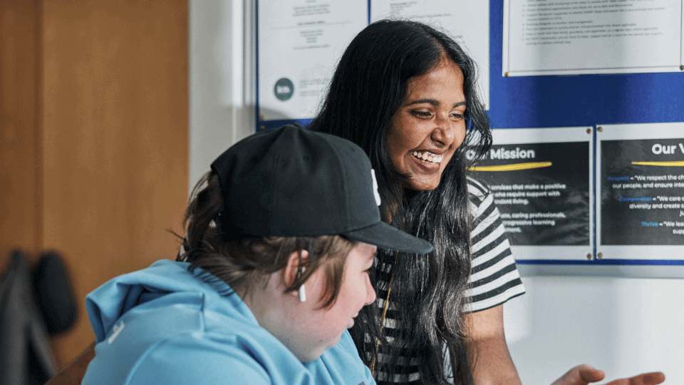Care Support Scotland - Support worker helps resident with computer
